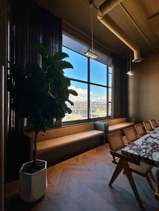 Interior of McKinley Studios office in Vancouver featuring marble table, wooden desk, and chairs, designed and installed by BWP Spaces