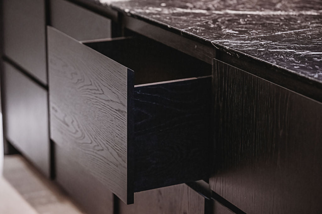 Dark wooden dresser with an open drawer. . BWP Spaces bespoke furniture and millwork at Checkmate Winery, BC