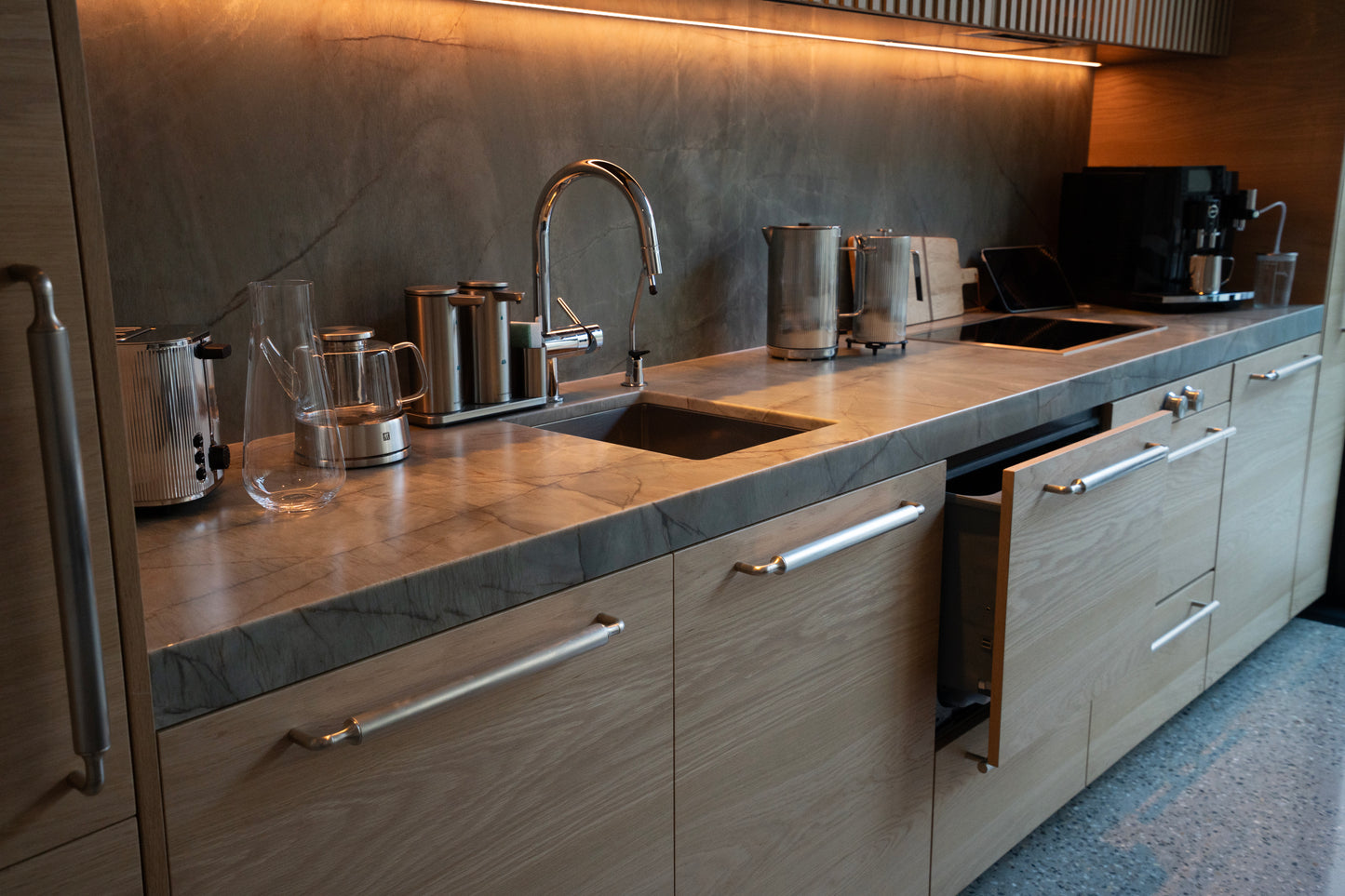 Modern kitchen with stainless steel appliances and wooden cabinets. BWP Spaces custom millwork in Kelowna, BC