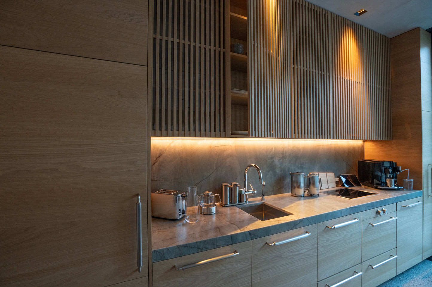 Modern kitchen with wooden cabinets, granite countertop, and stainless steel appliances.