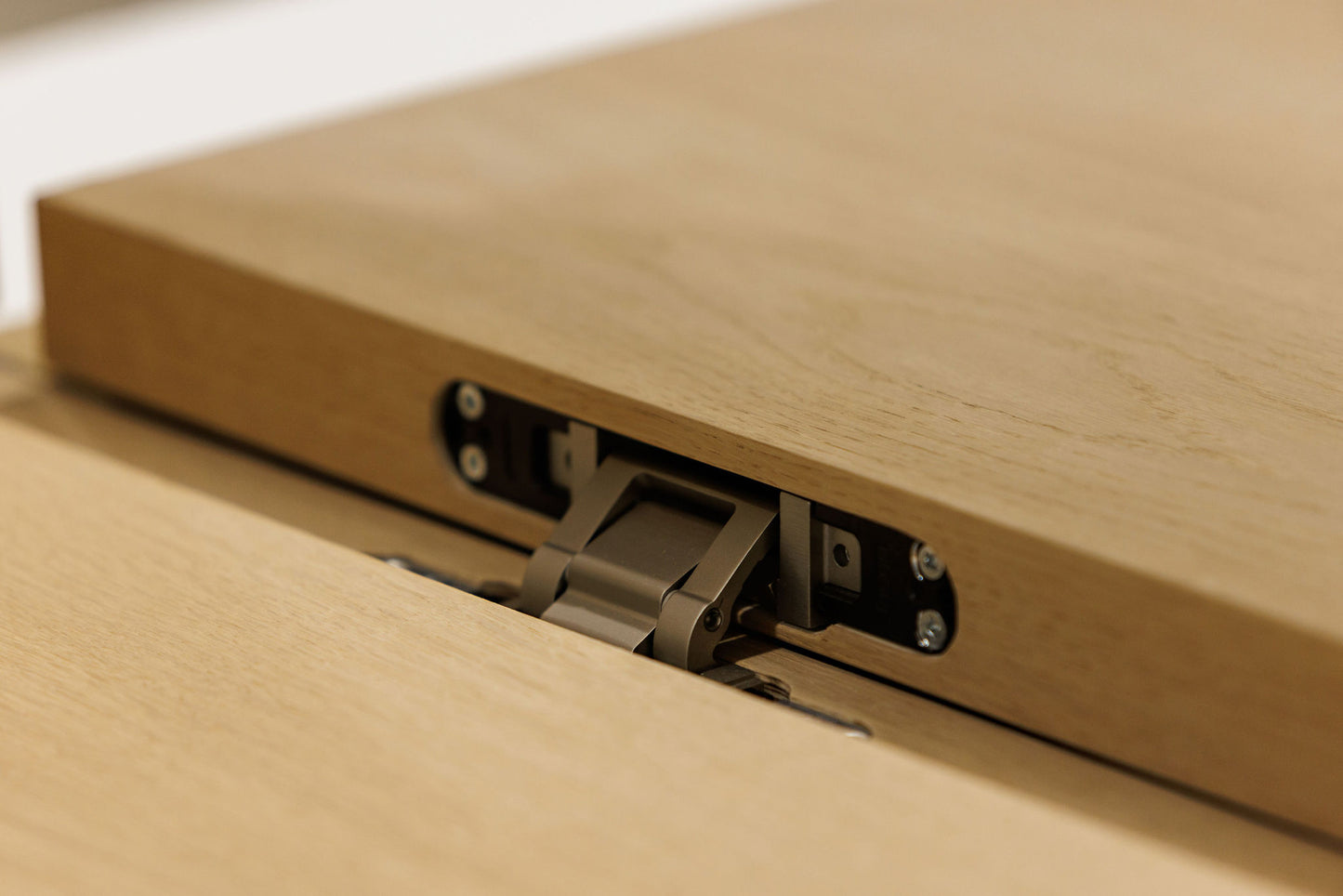 Close-up of a wooden box with a metal latch on a light background. BWP Spaces custom millwork in Kelowna, BC