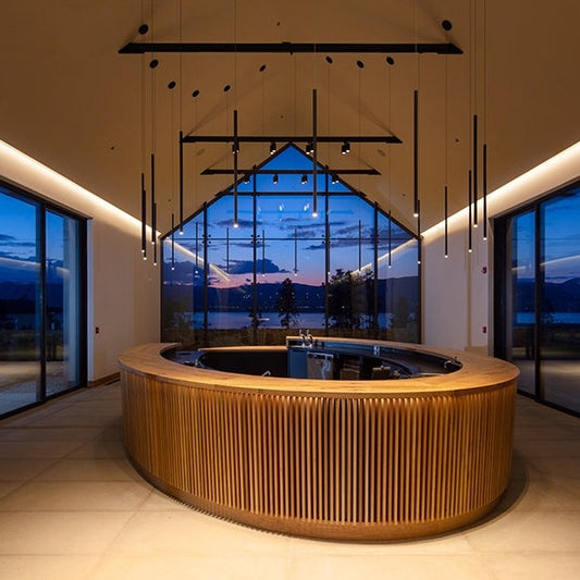 Interior of CedarCreek Estate Winery featuring custom oval tasting bar and retail shelving by BWP Spaces in collaboration with Erin Martin Design and Arcanum Architecture
